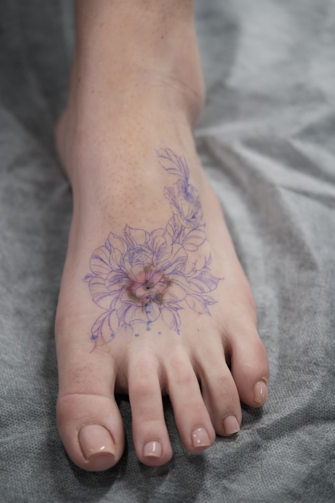 Floral foot tattoo before cover-up