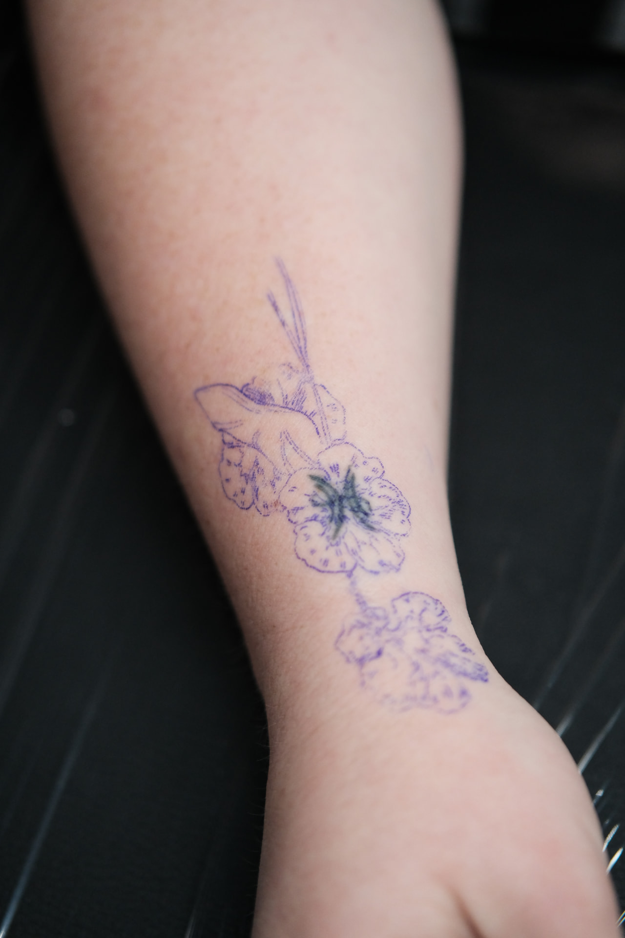 Floral wrist tattoo before cover-up
