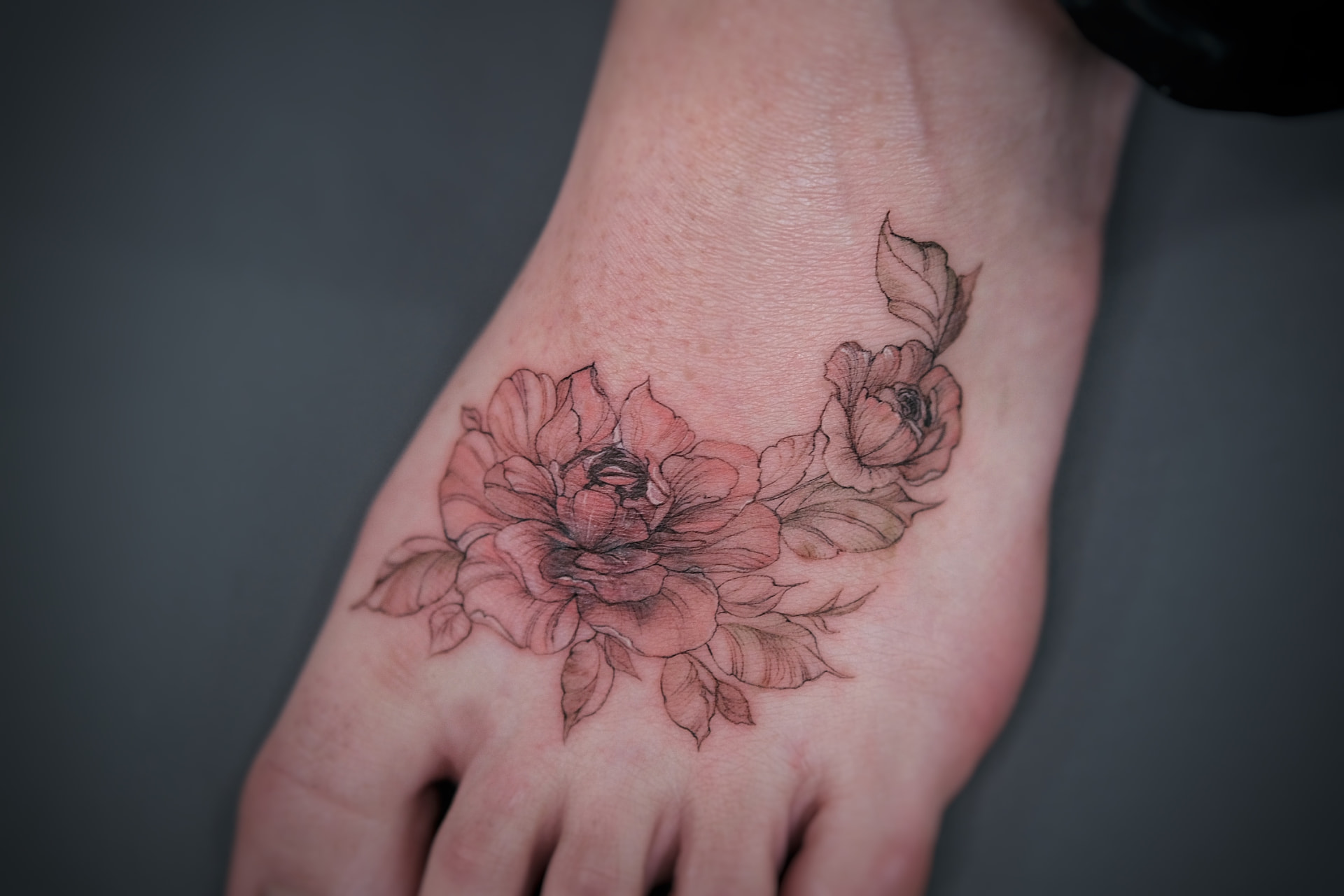Floral foot tattoo after cover-up